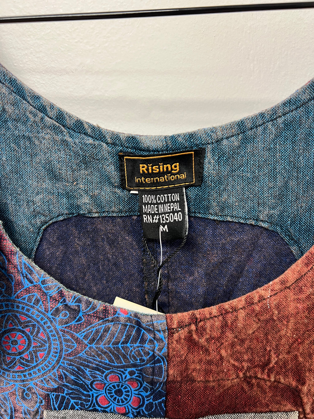 Rising International label: 100% cotton, made in Nepal, size medium